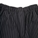 A close up of Mercer Culinary black pants with white pinstripes.