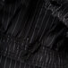 Mercer Culinary Millennia unisex black pinstripe chef pants. A close up of black and white pinstripe fabric.