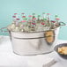 An American Metalcraft hammered silver party tub filled with bottles of beer on a counter.