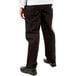 A person wearing Mercer Culinary Genesis black chef pants.