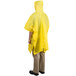 A person wearing a yellow Cordova rain poncho.