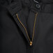 A close up of the zipper on Mercer Culinary black chef trousers.