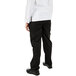 The back of a person wearing Mercer Culinary Genesis women's black cargo pants over a white shirt.