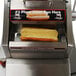 A Benchmark USA hot dog in a hot dog steamer.
