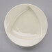 A white Tuxton china bowl with a triangle shaped design on the inside.