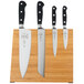 A group of Mercer Culinary Renaissance knives on a bamboo magnetic board.