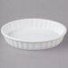 Acopa 5 oz. Oval Bright White Fluted Porcelain Souffle / Creme Brulee Dish - 36/Case Main Thumbnail 3