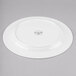 A white Reserve by Libbey bone china dinner plate with a circular design on it.