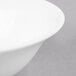 A close-up of a white Reserve by Libbey International Bone China bowl with a white rim.