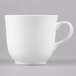 A white bone china tea cup with a handle.