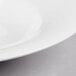 A close up of a white bowl with a black rim.