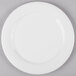 A white plate with a curved edge on a white surface.
