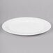 A white oval bone china platter with a white rim.
