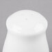 A white bone china pepper shaker with holes.