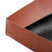 A close-up of a brown box with a black strip.