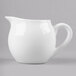 A white Reserve by Libbey bone china creamer with a handle.