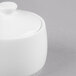 A white bone china sugar pot with a lid.