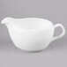 A white Reserve by Libbey bone china sauce boat with a handle.