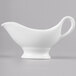 A white Reserve by Libbey bone china sauce boat on a gray background.