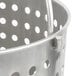A stainless steel Vollrath fryer basket with holes in it.