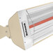 A tan and white Schwank electric patio heater with a red glow.