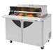 A Turbo Air 2 door stainless steel refrigerated sandwich prep table with food inside.