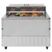 A Turbo Air refrigerated sandwich prep table with food trays in it.