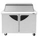 A white rectangular Turbo Air refrigerated sandwich prep table with black sliding lids over the top.