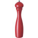 A red pepper mill with a silver top.