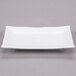 A bright white rectangular porcelain platter with a bamboo pattern.