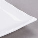 A bright white rectangular porcelain platter with a bamboo pattern.