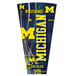 A yellow and blue University of Michigan logo on a blue round table top with a yellow letter and blue border.