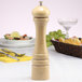 A wooden Chef Specialties Imperial pepper mill on a table.