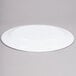 A white oval melamine platter with a circular rim.