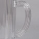A clear plastic Rubbermaid pitcher with a handle.