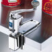 An Edlund U-12 SL Heavy Duty Manual Can Opener on a counter with a metal knob.