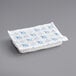 A white rectangular foam brick with blue and white packaging designs.