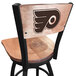 A black steel Holland Bar Stool Philadelphia Flyers bar height swivel chair with maple back and seat and laser engraved logo.