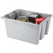A gray Rubbermaid Palletote container with food in it.