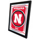 A red and silver framed mirror with the University of Nebraska logo.