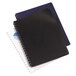 A close-up of a black spiral bound notebook with a black leather-look cover.
