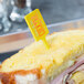A sandwich with a WNA Comet yellow rectangular pick in it.