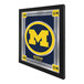 A white framed mirror with a black University of Michigan logo.