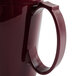 A close-up of a Cambro cranberry insulated mug with a handle.