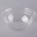 A clear plastic squat bowl with a clear plastic lid with a circular pattern on the rim.