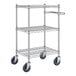 A Regency chrome metal cart with three wire shelves and wheels.