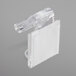 A clear plastic Snap Drape table skirt clip with a white plastic strip.