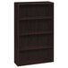 A dark wood HON 10700 Series bookcase with four shelves.