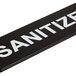 A black rectangular Vollrath Traex sign with white text that says "Sanitize"