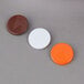 A group of Vollrath SwirlServe tab sets with orange, brown, and white buttons.